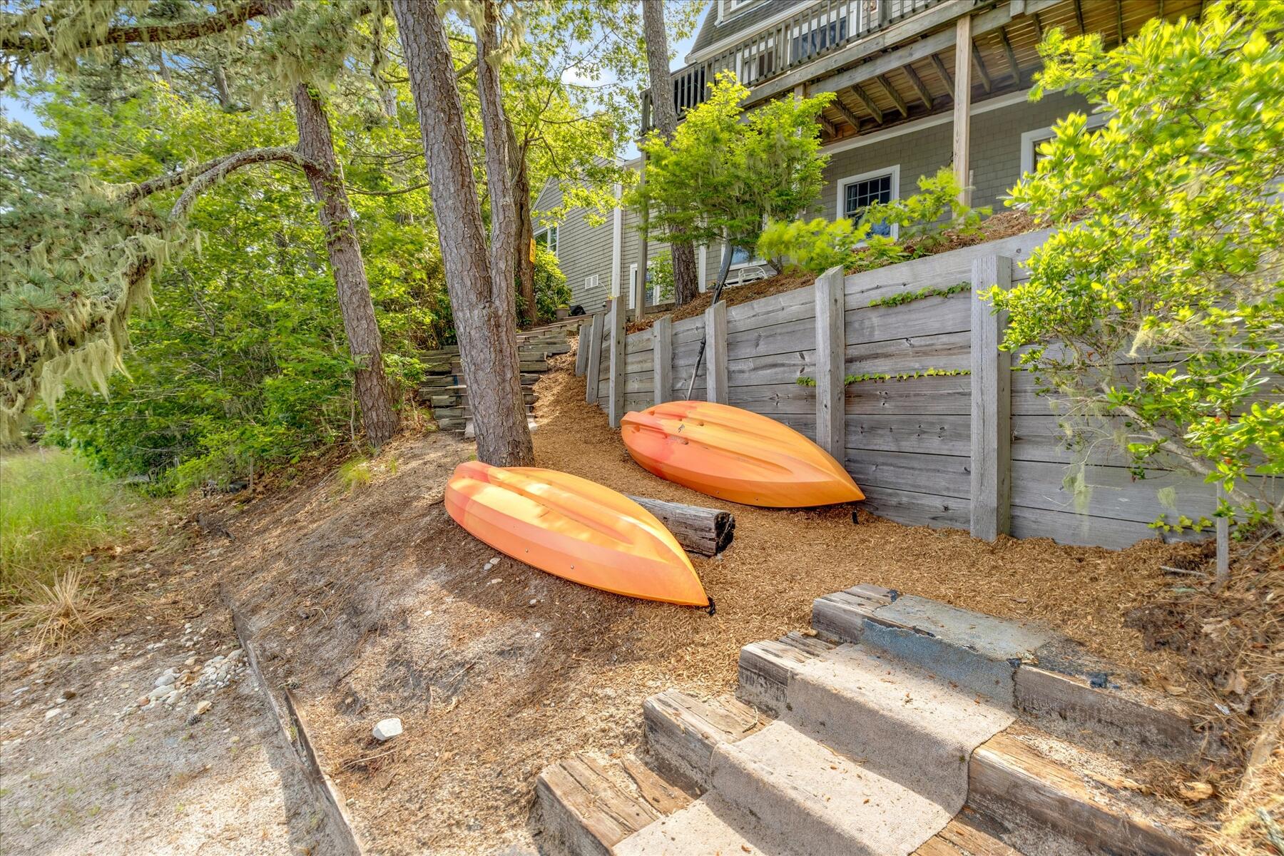 194 John Joseph Road Harwich, MA 02645 - Photo 71 of 87 a view of a backyard with table and chairs and wooden fence