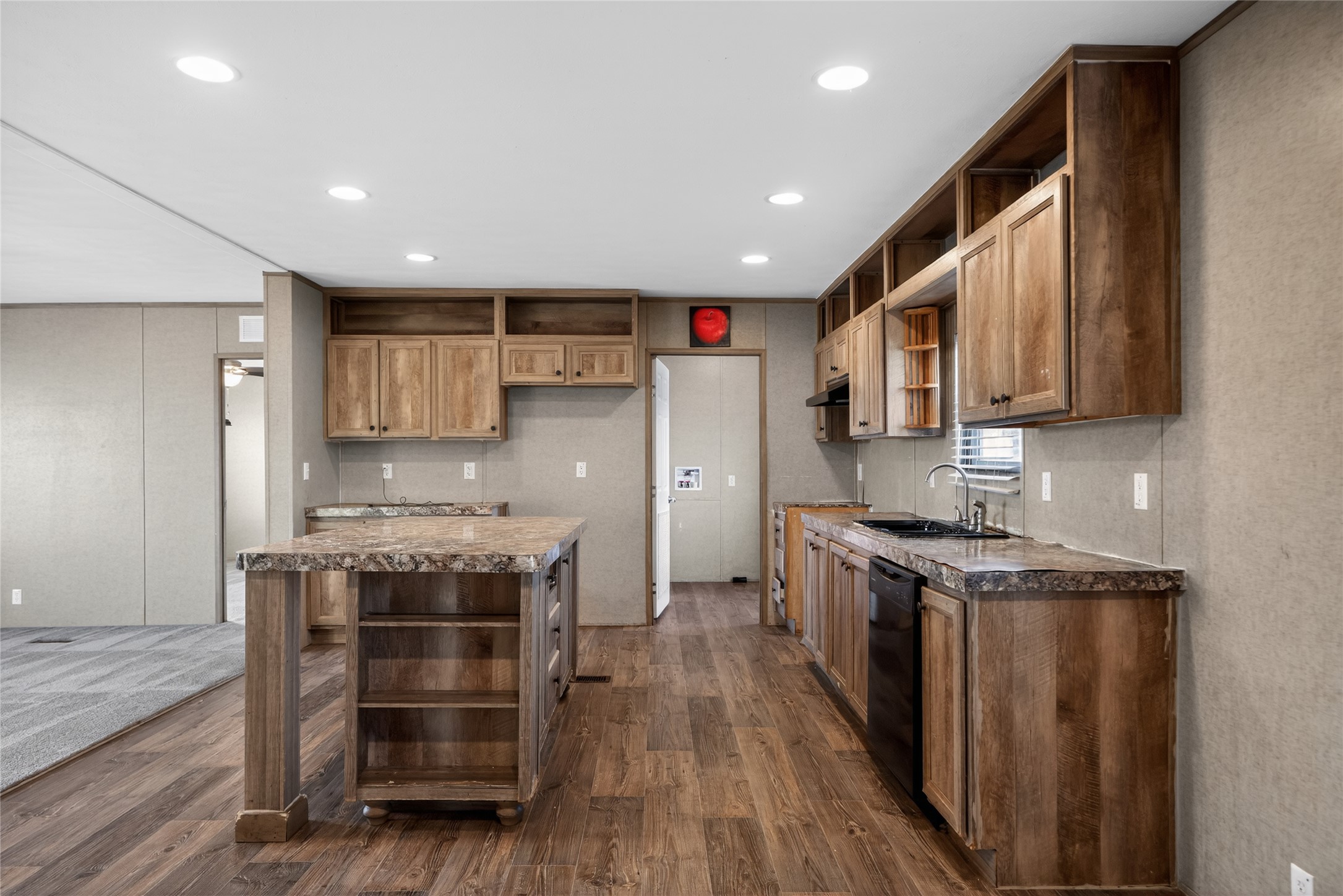 2674 Cotton Gin Road Kyle, TX 78640 - Photo 20 of 30 Kitchen featuring open shelves, a center island, dark wood-type flooring, dishwasher, and recessed lighting