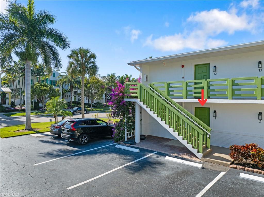 975 9th Avenue South, Unit 1 Naples, FL 34102 - Photo 2 of 34 a car parked in front of house with potted plants
