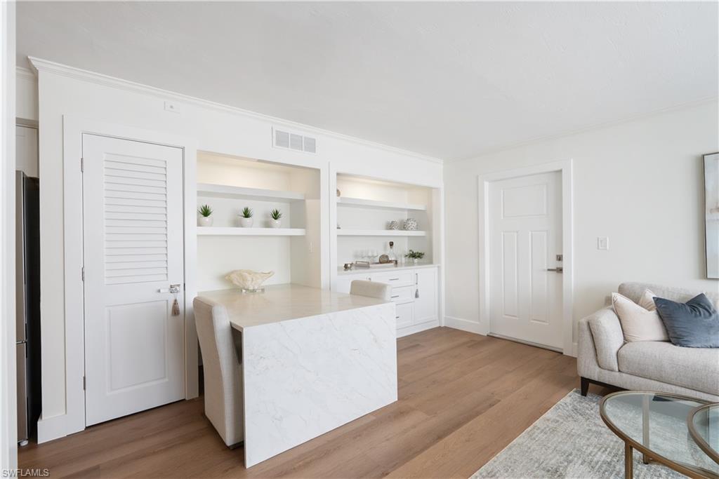 975 9th Avenue South, Unit 1 Naples, FL 34102 - Photo 23 of 34 a living room with stainless steel appliances wooden floor and a window