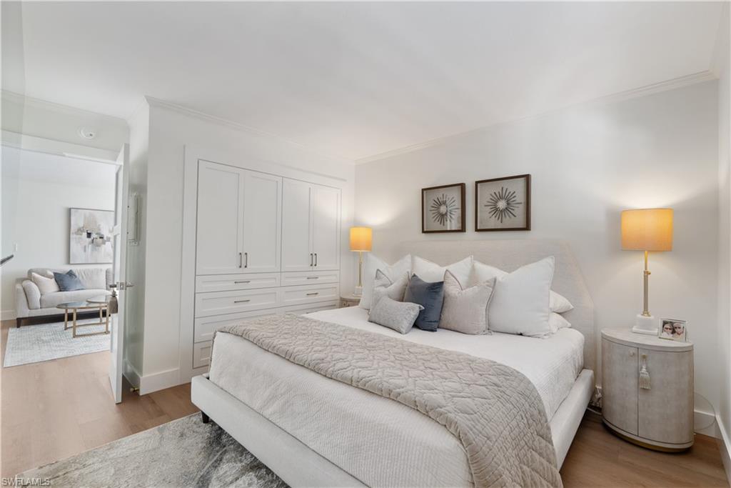 975 9th Avenue South, Unit 1 Naples, FL 34102 - Photo 32 of 34 a bedroom with a bed and a lamp