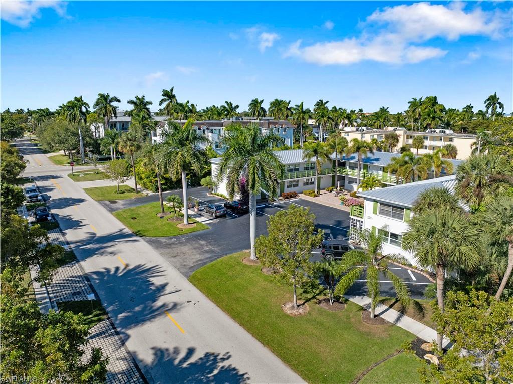 975 9th Avenue South, Unit 1 Naples, FL 34102 - Photo 8 of 34 a view of a swimming pool with a yard