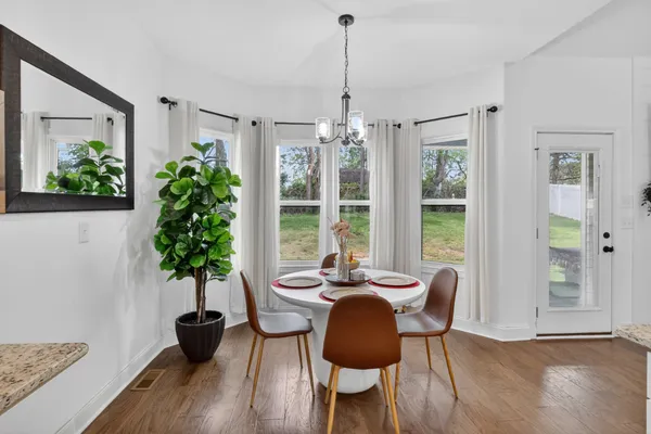 a view of a dining room with furniture window and wooden floor