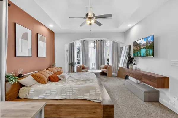 a bedroom with a bed window and couch