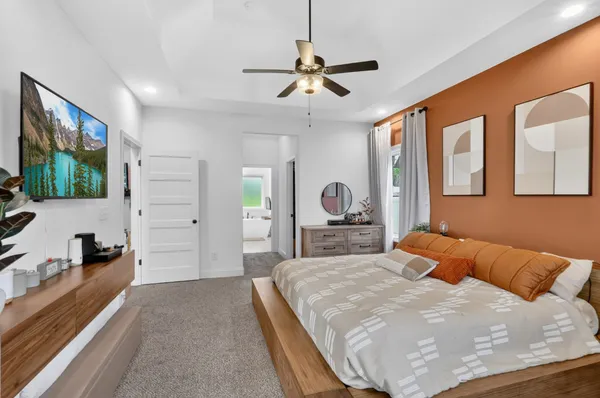 a bedroom with a bed and a flat screen tv