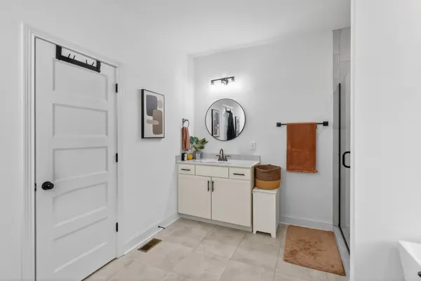 a bathroom with a sink a mirror and shower
