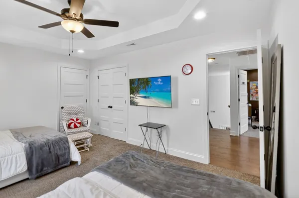 a bedroom with a bed and a chandelier