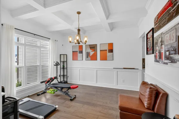 a living room with furniture windows and a chandelier