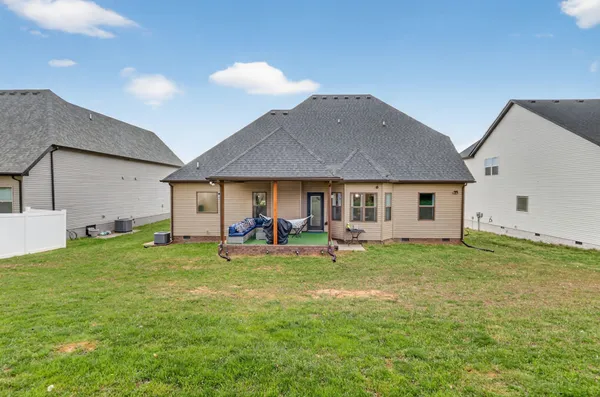 a backyard of a house with table and chairs