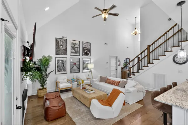 a living room with furniture and a potted plant
