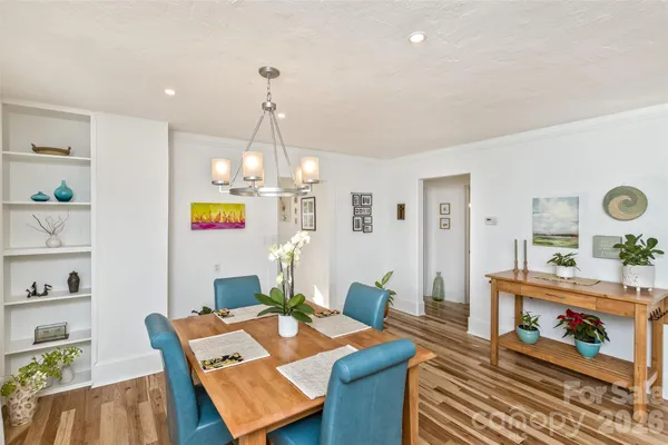 a bedroom with a large bed and a painting on the wall