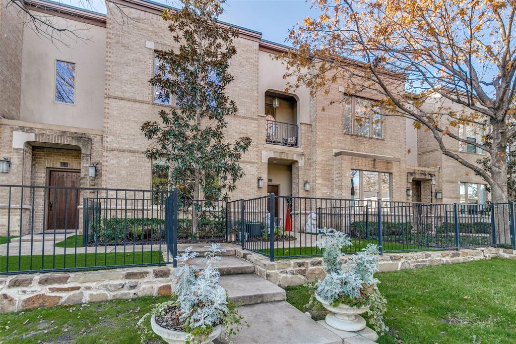 6269 Oram Street, Unit 26 Dallas, TX 75214 - Photo 1 of 1 a front view of a house with a garden and trees