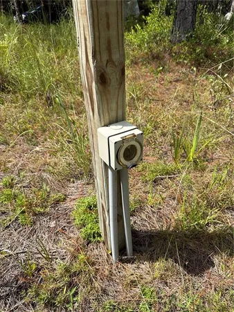 a view of backyard with table and chairs under an umbrella