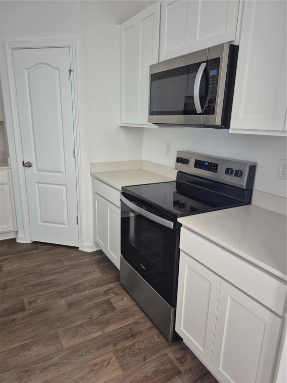 7 Ryall Lane, Unit B Palm Coast, FL 32164 - Photo 11 of 22 a kitchen with cabinets and steel appliances