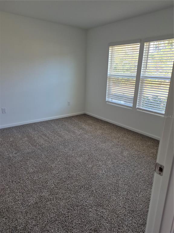 7 Ryall Lane, Unit B Palm Coast, FL 32164 - Photo 14 of 22 an empty room with a window