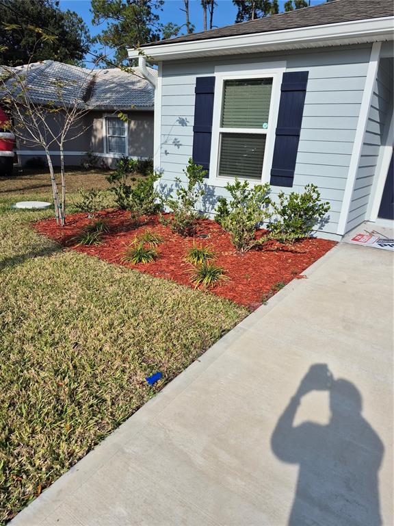 7 Ryall Lane, Unit B Palm Coast, FL 32164 - Photo 2 of 22 a front view of a house with garden