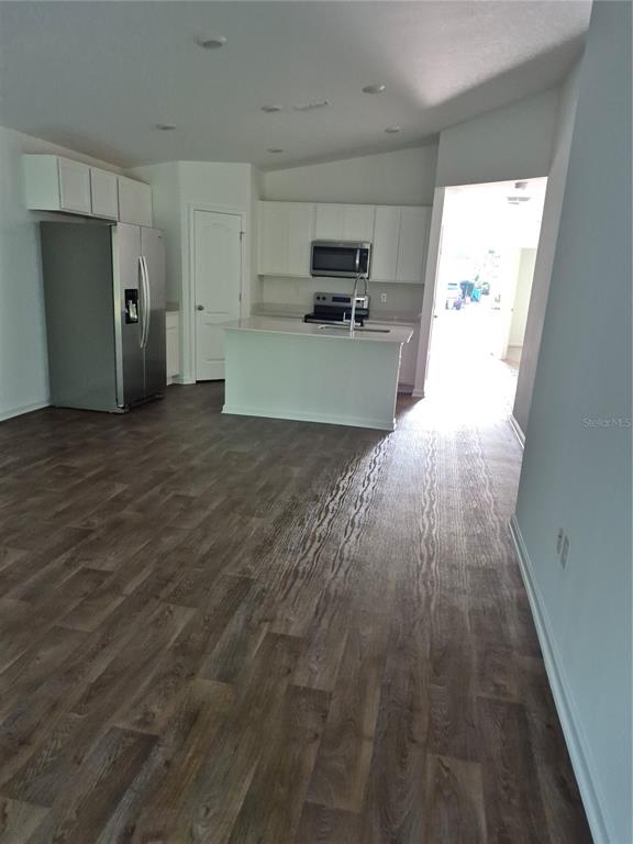 7 Ryall Lane, Unit B Palm Coast, FL 32164 - Photo 21 of 22 a view of a kitchen with a sink and a refrigerator
