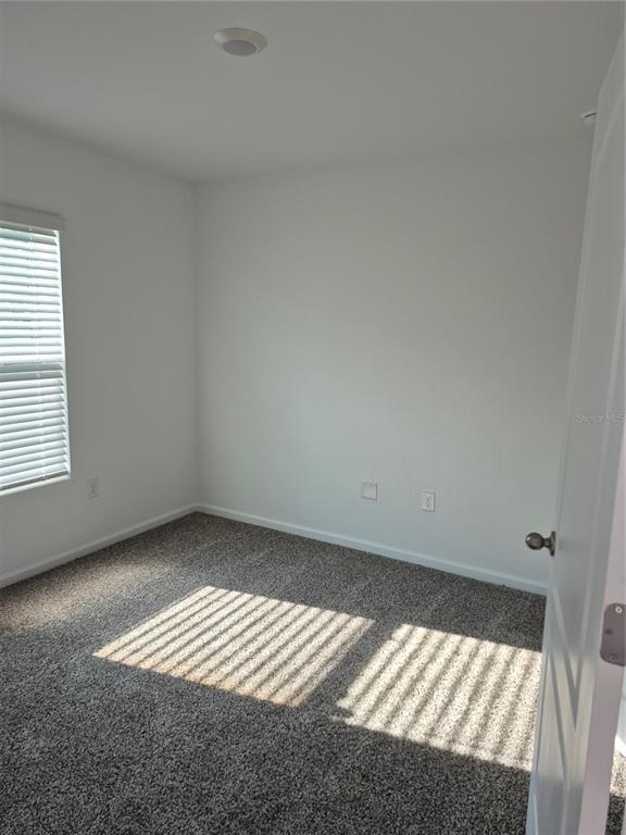 7 Ryall Lane, Unit B Palm Coast, FL 32164 - Photo 4 of 22 an empty room with a window