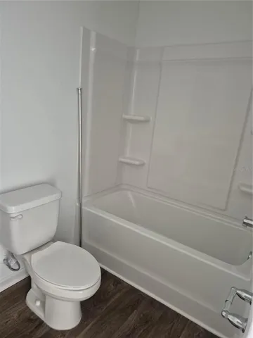a bathroom with a toilet and a bath tub