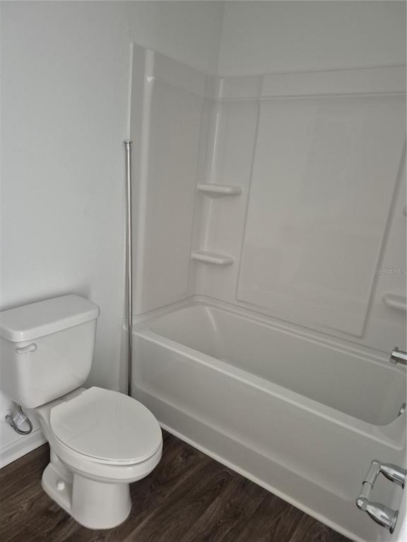7 Ryall Lane, Unit B Palm Coast, FL 32164 - Photo 6 of 22 a bathroom with a toilet and a bath tub