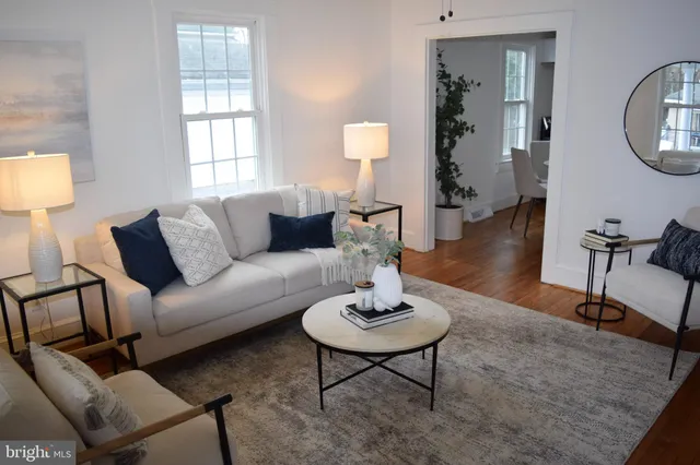 a kitchen with a refrigerator a white table and chairs