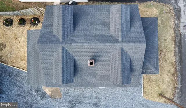 a living room with furniture and a mirror