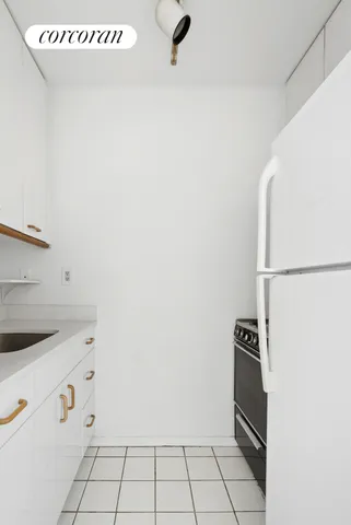 a view of kitchen with white cabinets
