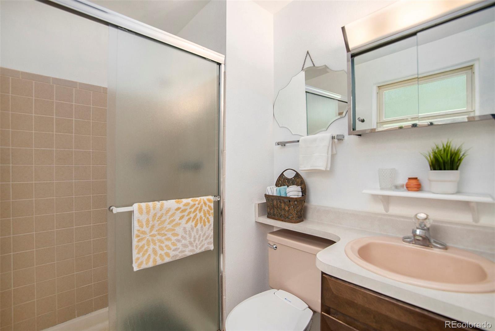 6180 South Ash Circle West Centennial, CO 80121 - Photo 13 of 23 a bathroom with a sink a toilet and mirror