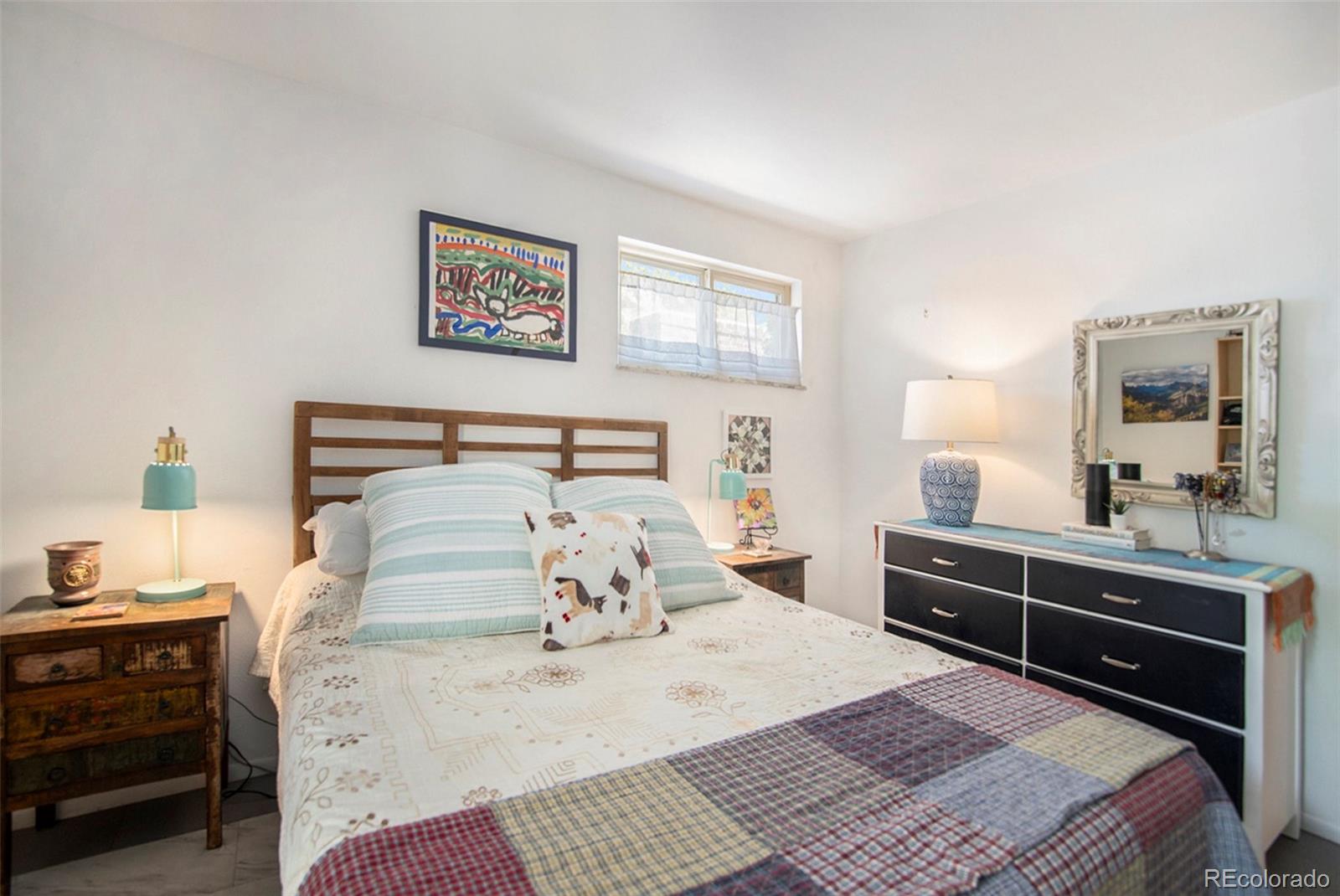 6180 South Ash Circle West Centennial, CO 80121 - Photo 14 of 23 a bedroom with a bed and a dresser in it