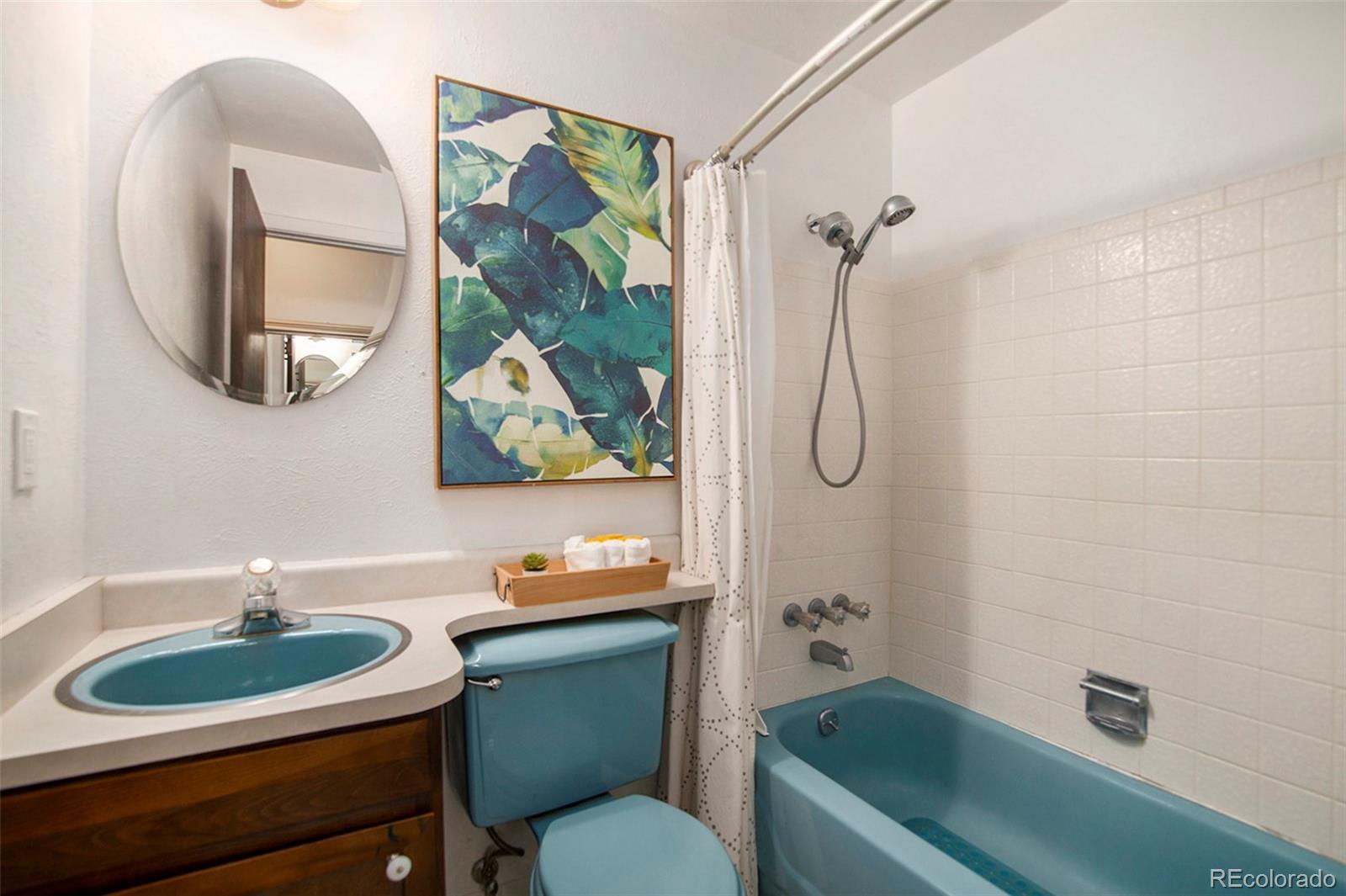 6180 South Ash Circle West Centennial, CO 80121 - Photo 16 of 23 a bathroom with a sink toilet and a mirror