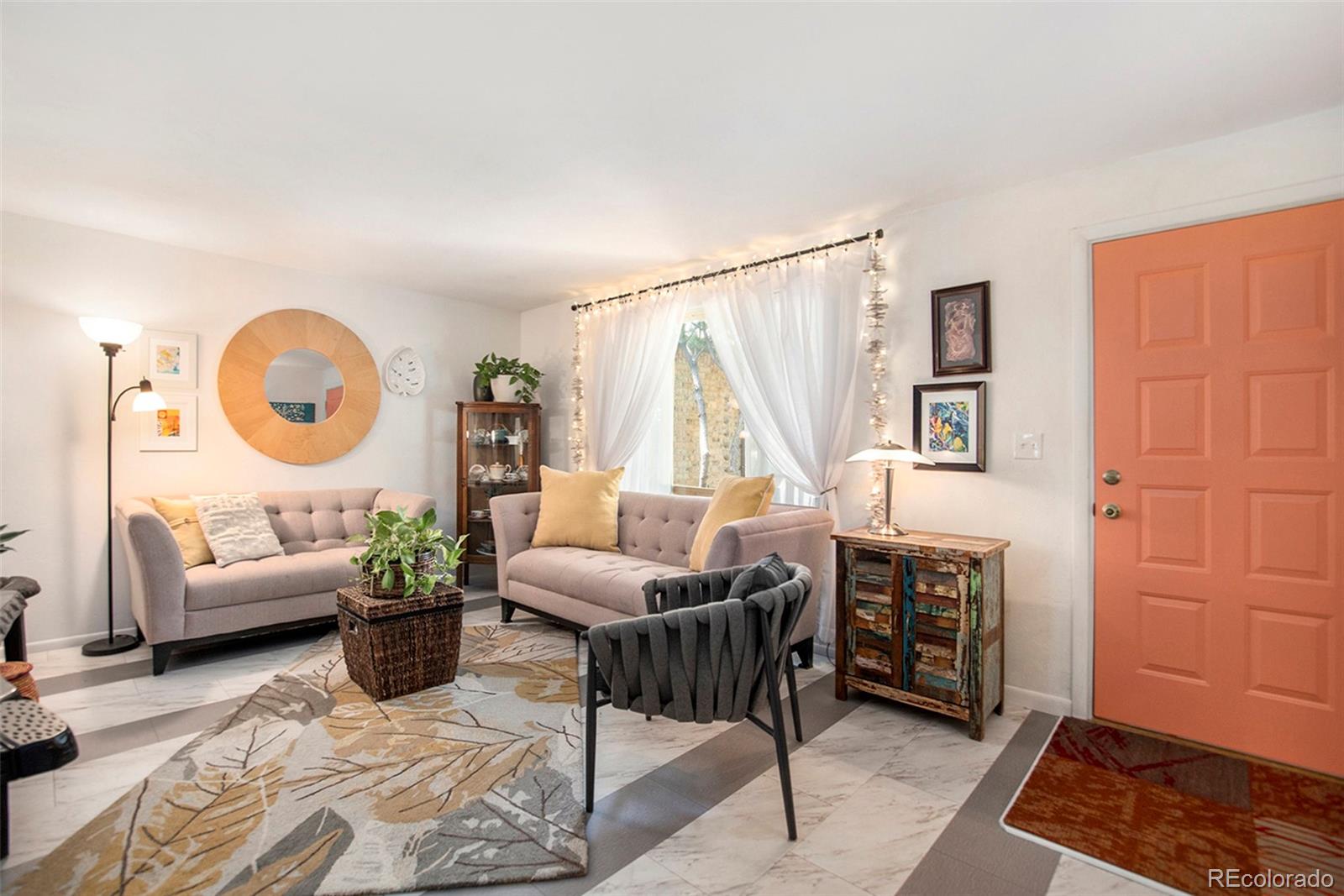 6180 South Ash Circle West Centennial, CO 80121 - Photo 4 of 23 a living room with furniture a rug and a window