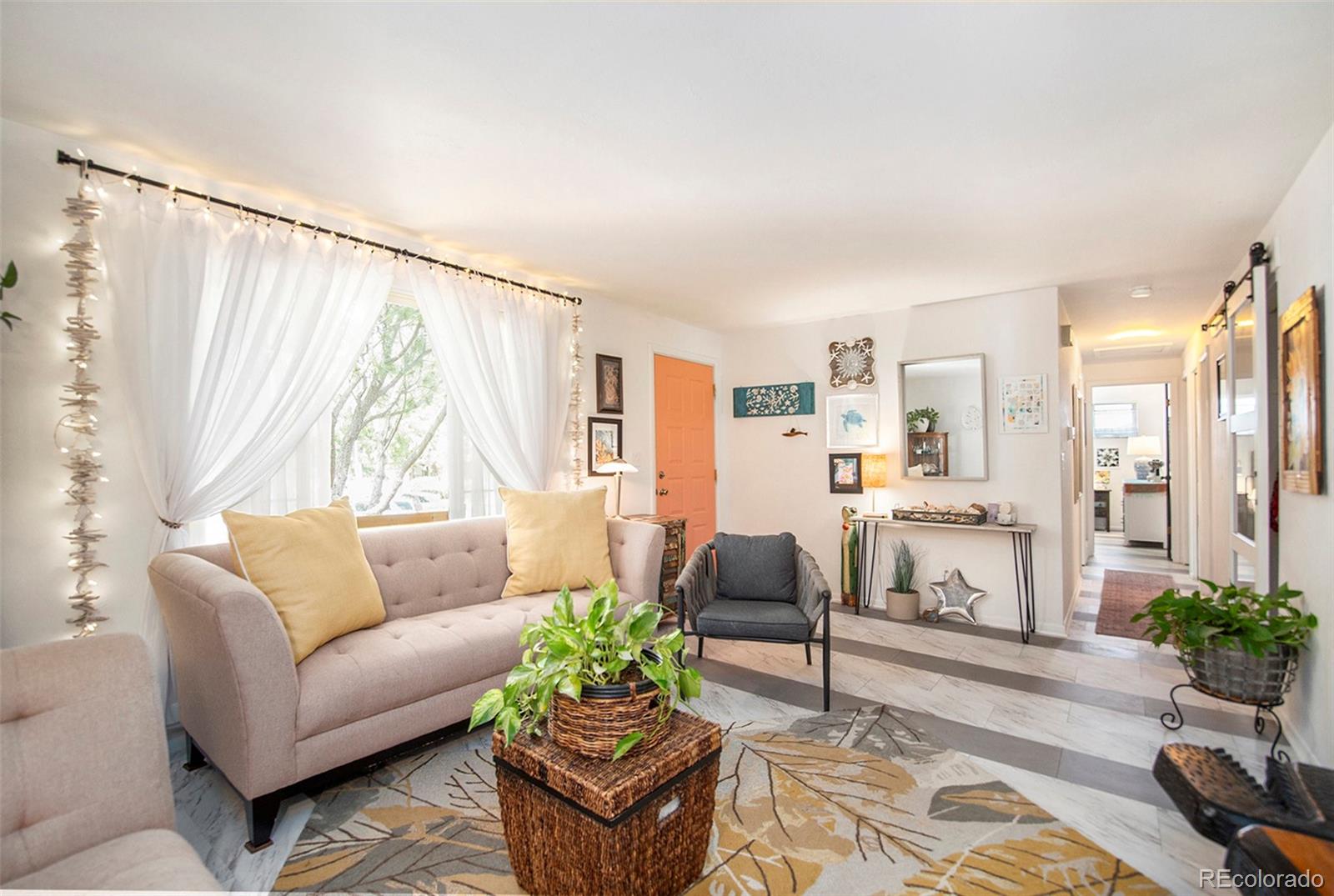 6180 South Ash Circle West Centennial, CO 80121 - Photo 5 of 23 a living room with furniture and a large window