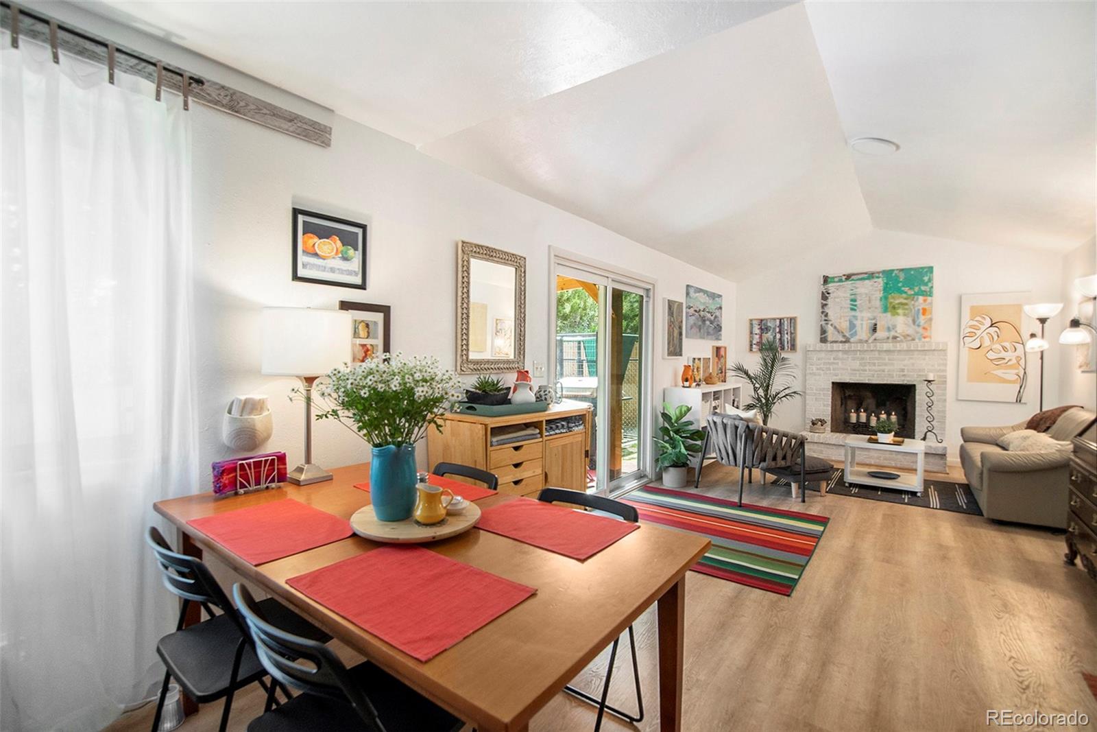 6180 South Ash Circle West Centennial, CO 80121 - Photo 8 of 23 a view of a dining room with furniture window and wooden floor
