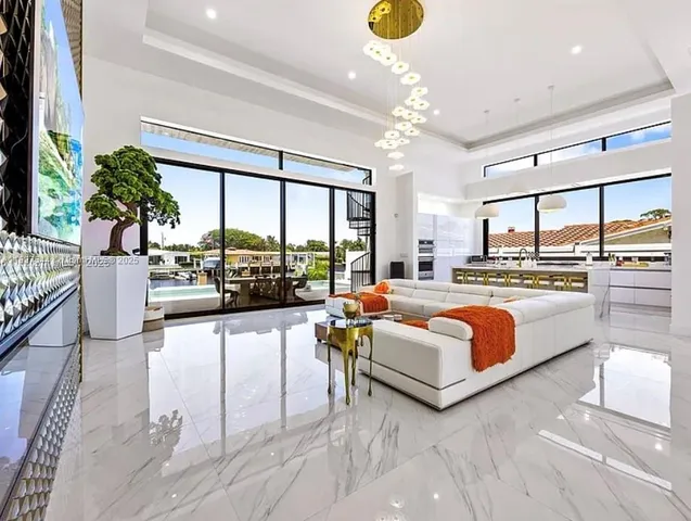 a large kitchen with stainless steel appliances kitchen island granite countertop a sink and a counter top space