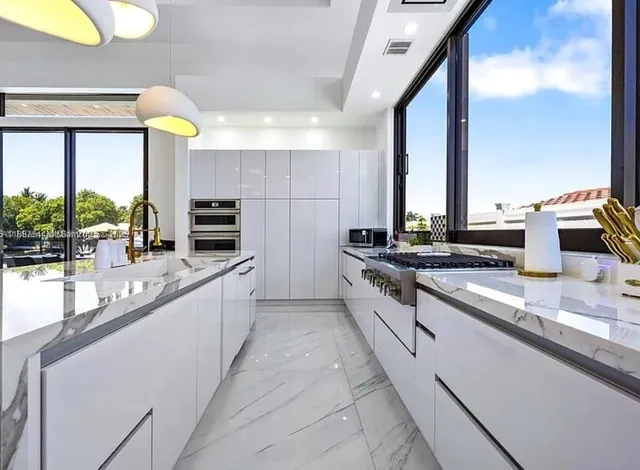 a kitchen with stainless steel appliances a sink a stove and a refrigerator