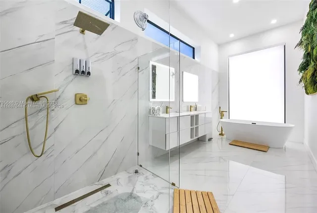 a bathroom with a granite countertop sink a toilet and shower