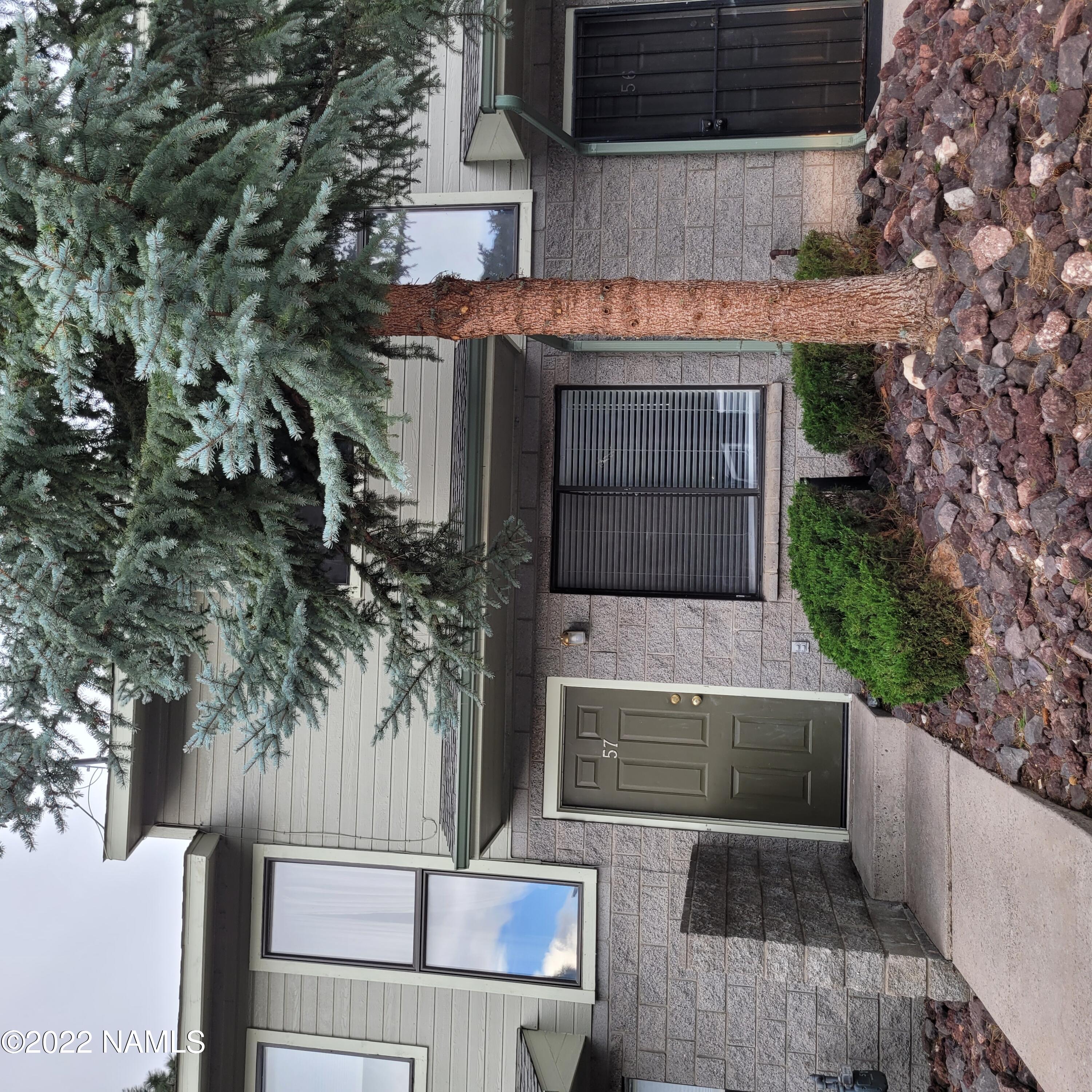 6315 St Nicholas Circle, Unit 57 Flagstaff, AZ 86004 - Photo 1 of 5 a house that has a tree in front of the house