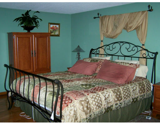 1 Mountain Road, Unit B Gill, MA 01354 - Photo 19 of 30 a bed sitting in a bedroom next to a wooden door