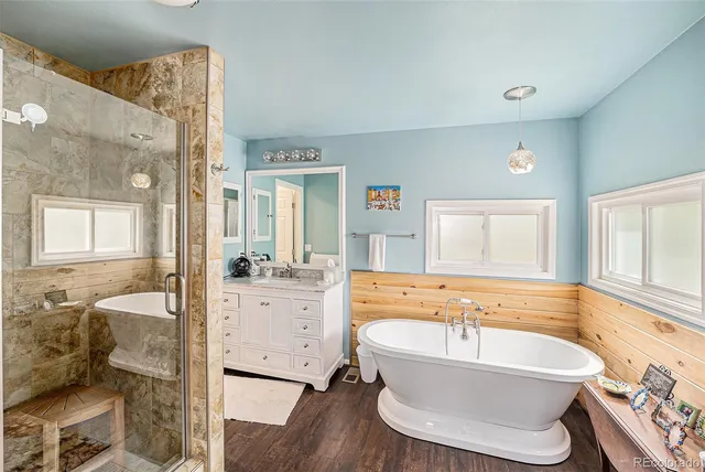 a spacious bathroom with sink shower bathtub and window