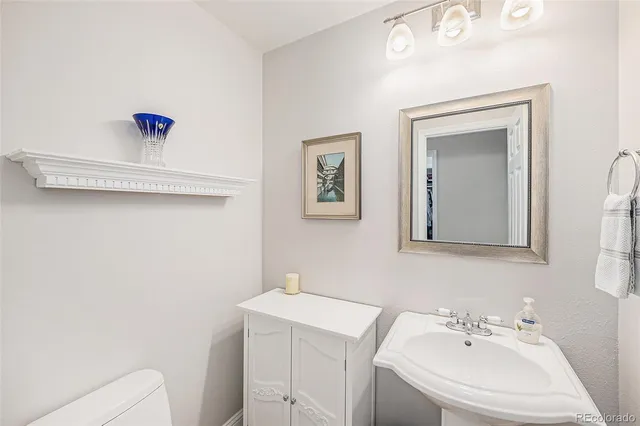 a bathroom with a sink mirror and vanity