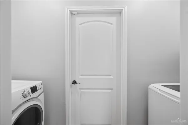a view of storage and utility room with washer and dryer
