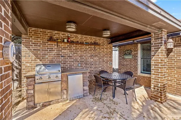 a brick building with a bench and a barbeque