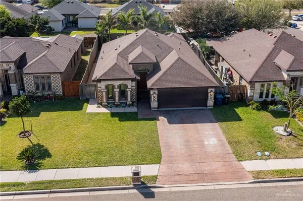 a view of house with garden space and sitting area
