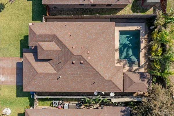 an aerial view of a house with a yard