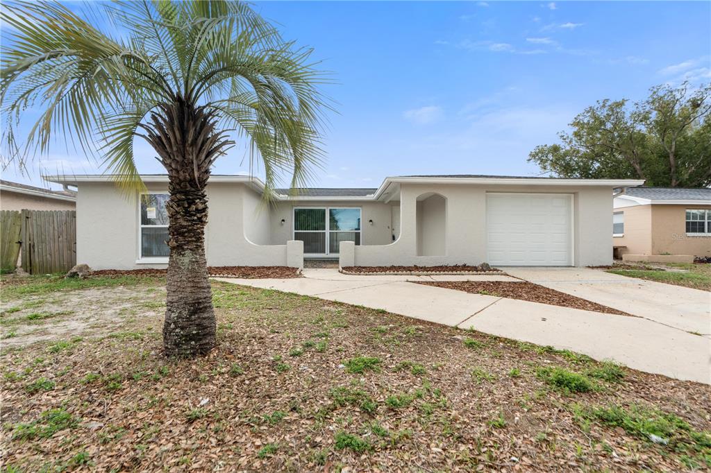 7134 Fox Hollow Drive Port Richey, FL 34668 - Photo 1 of 1 a front view of house with yard and garage