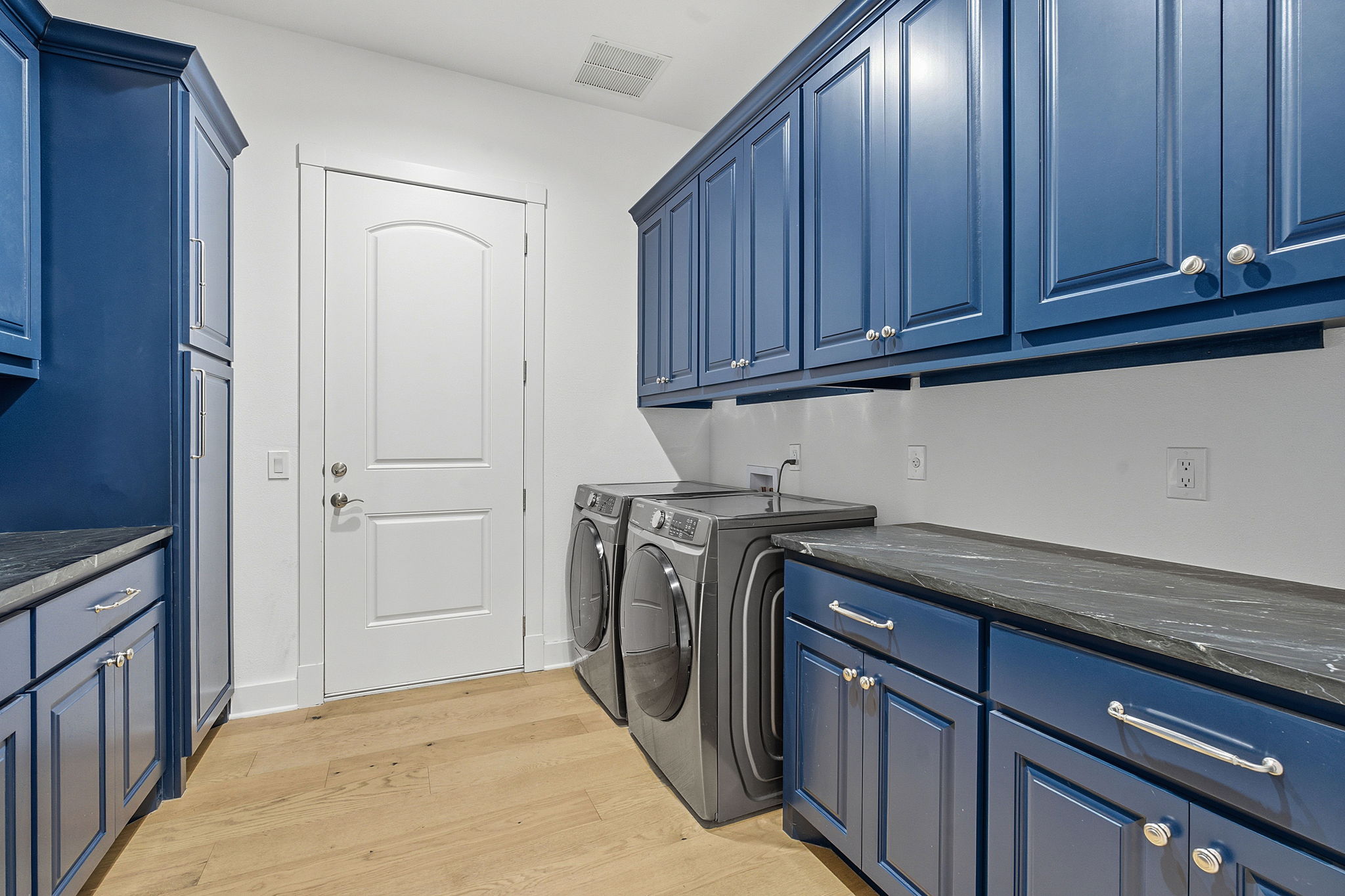16400 Hamilton Pool Road Austin, TX 78738 - Photo 18 of 37 a utility room with granite countertop cabinets washer and dryer