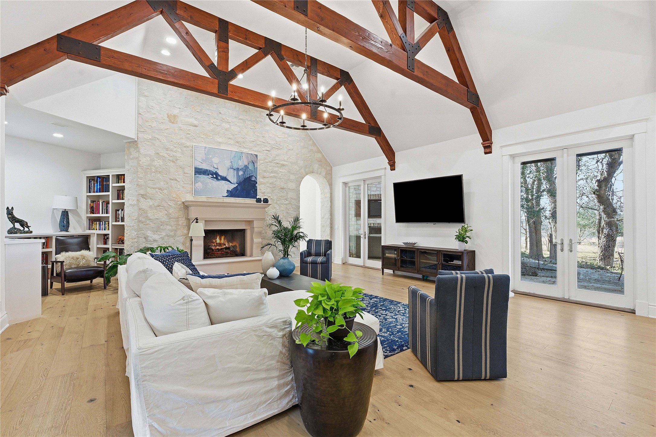 16400 Hamilton Pool Road Austin, TX 78738 - Photo 8 of 37 a living room with furniture a flat screen tv and a fireplace