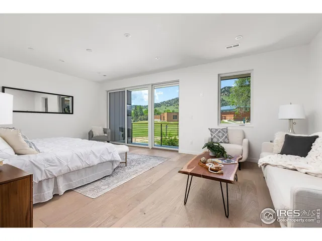 a living room with furniture a flat screen tv and a large window