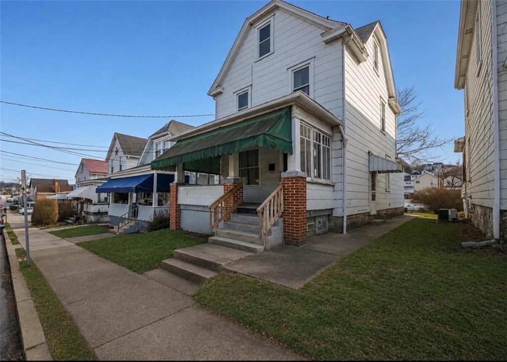325 Walnut Street Vandergrift, PA 15690 - Photo 1 of 29 a front view of a house with garden