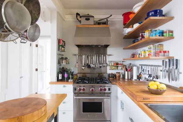 a kitchen with stainless steel appliances granite countertop a refrigerator and a stove